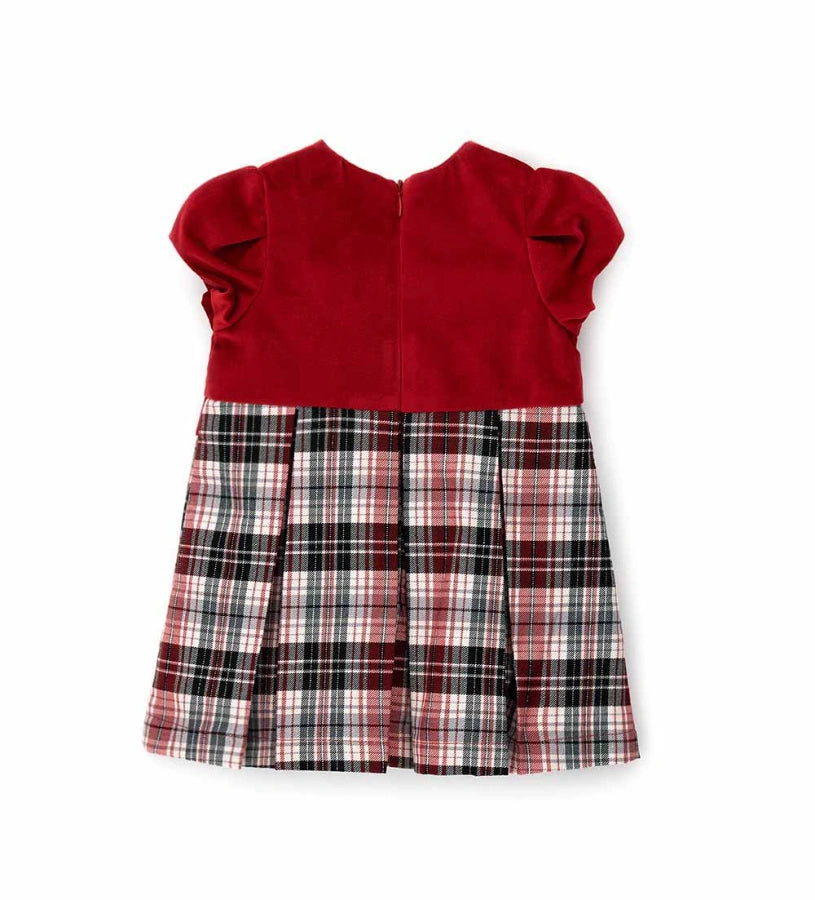 Φόρεμα δύο υφών με βελούδινο επάνω μέρος, κοντά φουσκωτά μανίκια και καρό κάτω μέρος με βαμβακερή φόδρα. Διαθέτει φιόγκο στη μέση, κέντημα στην πλευρά της καρδιάς και κρυφό φερμουάρ στο πίσω μέρος.