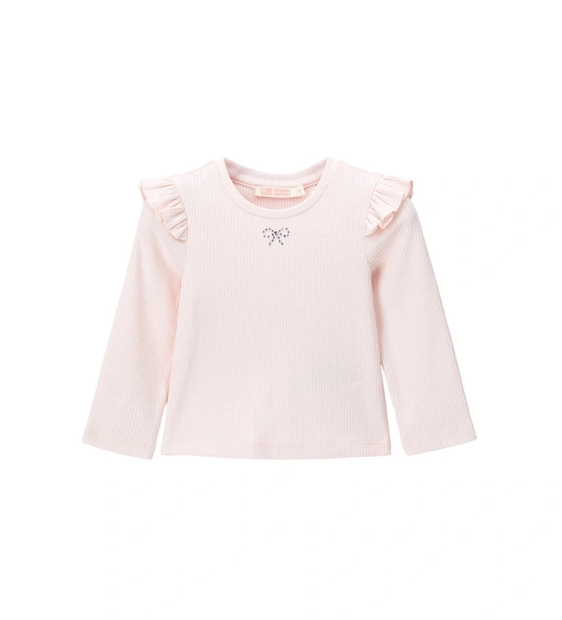 Σετ με φόρεμα από ύφασμα τύπου μάλλινο και μπλούζα ριπ με βολάν στους ώμους. Η μπλούζα είναι διακοσμημένη με στρας στο μπροστινό μέρος, ενώ το φόρεμα διαθέτει πλαϊνά κουμπιά για εύκολο φόρεμα. Ένα γλυκό και κομψό σετ, ιδανικό για κοριτσίστικες εμφανίσεις με ρομαντική και εκλεπτυσμένη πινελιά.