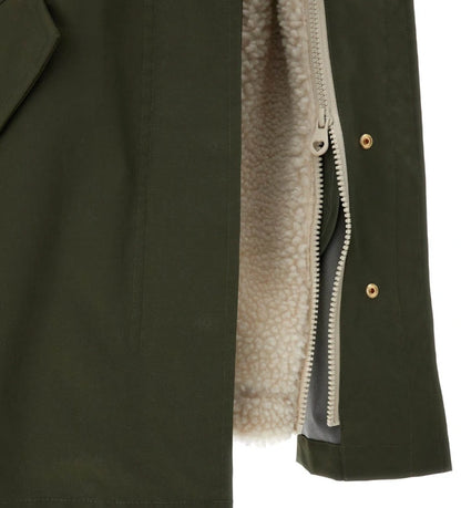 Μακρύ παρκά με κουκούλα και αποσπώμενη επένδυση από οικολογική γούνα μέσω κρυφών φερμουάρ. Κλείσιμο με φερμουάρ και κουμπιά σούστες, μπροστινές τσέπες και διακοσμημένο έμβλημα με στρας. Ένα πρακτικό και ταυτόχρονα λαμπερό ρούχο, ιδανικό για κομψές και ζεστές χειμερινές εμφανίσεις.