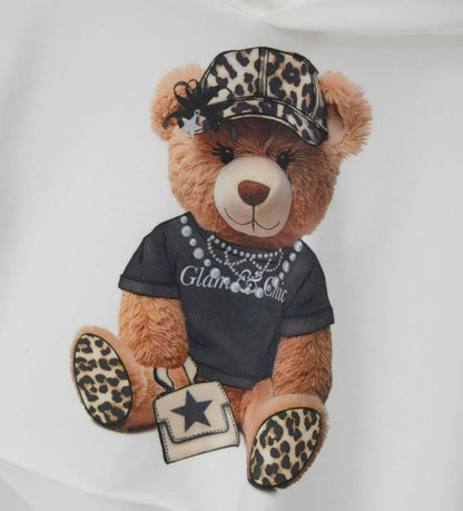 Κοντό φούτερ με κουκούλα από ελαστικό βαμβάκι και μακριά μανίκια. Τύπωμα με glitter και μισές πέρλες στο μπροστινό μέρος για ένα μοντέρνο και λαμπερό στυλ.