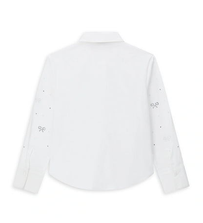 Παιδικό πουκάμισο από βαμβάκι με κουμπιά στο μπροστινό μέρος, μακριά μανίκια και μανσέτες με κουμπί. Διαθέτει αφαιρούμενο φιόγκο από λαμιναρισμένο ύφασμα και στρας στο μπροστινό μέρος και στα μανίκια για ένα λαμπερό και μοντέρνο στυλ.
