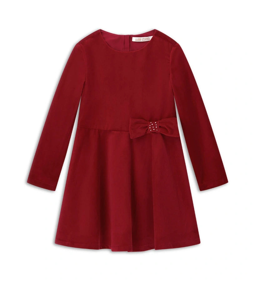 Φόρεμα από βελούδο με στρογγυλή λαιμόκοψη και κλείσιμο στο πίσω μέρος με αόρατο φερμουάρ. Μακριά μανίκια και βαμβακερή φόδρα, διακοσμημένο με φιόγκο στη μέση για ένα κομψό και εκλεπτυσμένο look.