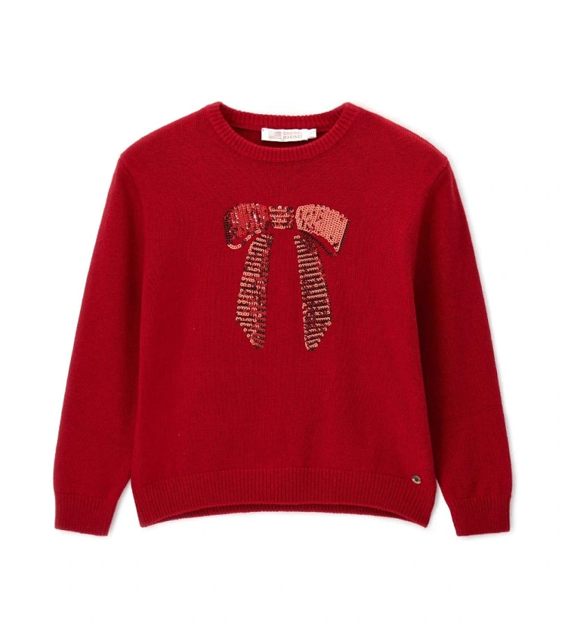 Πλεκτή μπλούζα από μείγμα μαλλιού με στρογγυλή λαιμόκοψη και ριμπ τελειώματα σε λαιμό και μανσέτες. Μαλακή, ζεστή και εκλεπτυσμένη, διακοσμημένη με μεταλλικό μενταγιόν μπροστά για μια κομψή λεπτομέρεια.