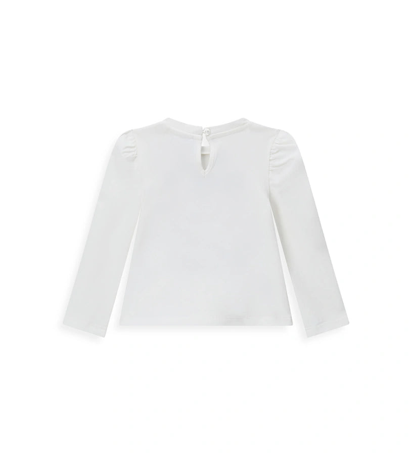 Λευκή μπλούζα Disney Minnie Mouse από ελαστικό βαμβάκι με στρογγυλή λαιμόκοψη, μακριά μανίκια με βολάν, δάκρυ άνοιγμα με κουμπί στο πίσω μέρος και μπροστινό τύπωμα με γκλίτερ λεπτομέρειες.