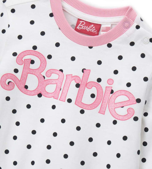 Πυτζάμα βαμβακερή Barbie, με μπλούζα με στρογγυλή λαιμόκοψη, allover τύπωμα με glitter, άνοιγμα στον ώμο και ριμπ τελειώματα, και παντελόνι σετ με φιόγκο και allover τύπωμα.