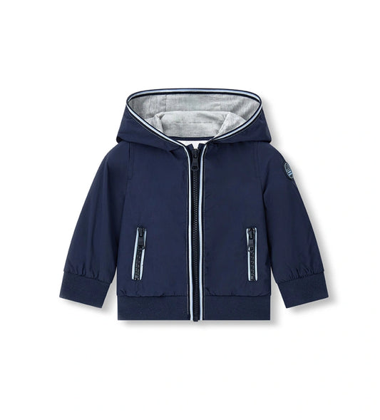 Παιδικό αντιανεμικό μπουφάν για αγόρι σε σκούρο μπλε χρώμα με κουκούλα και φερμουάρ.