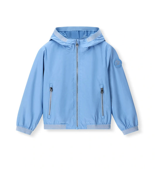 Παιδικό αντιανεμικό μπουφάν για κορίτσι σε γαλάζιο χρώμα με κουκούλα και lurex άκρες.