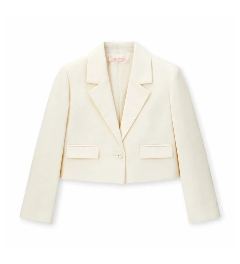 Παιδικό blazer για κορίτσι σε κοντή γραμμή κρεμ χρώματος με γιακά πέτο.