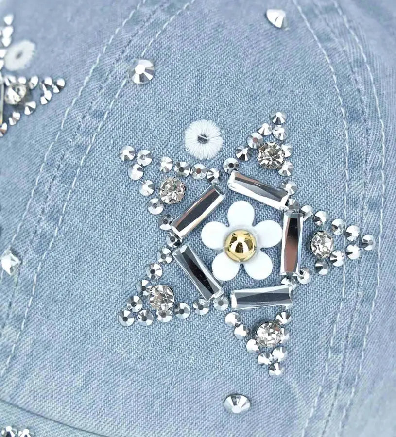 Κοντινό πλάνο στα λαμπερά στρασάκια και την ποιότητα του denim υφάσματος στο παιδικό καπέλο.